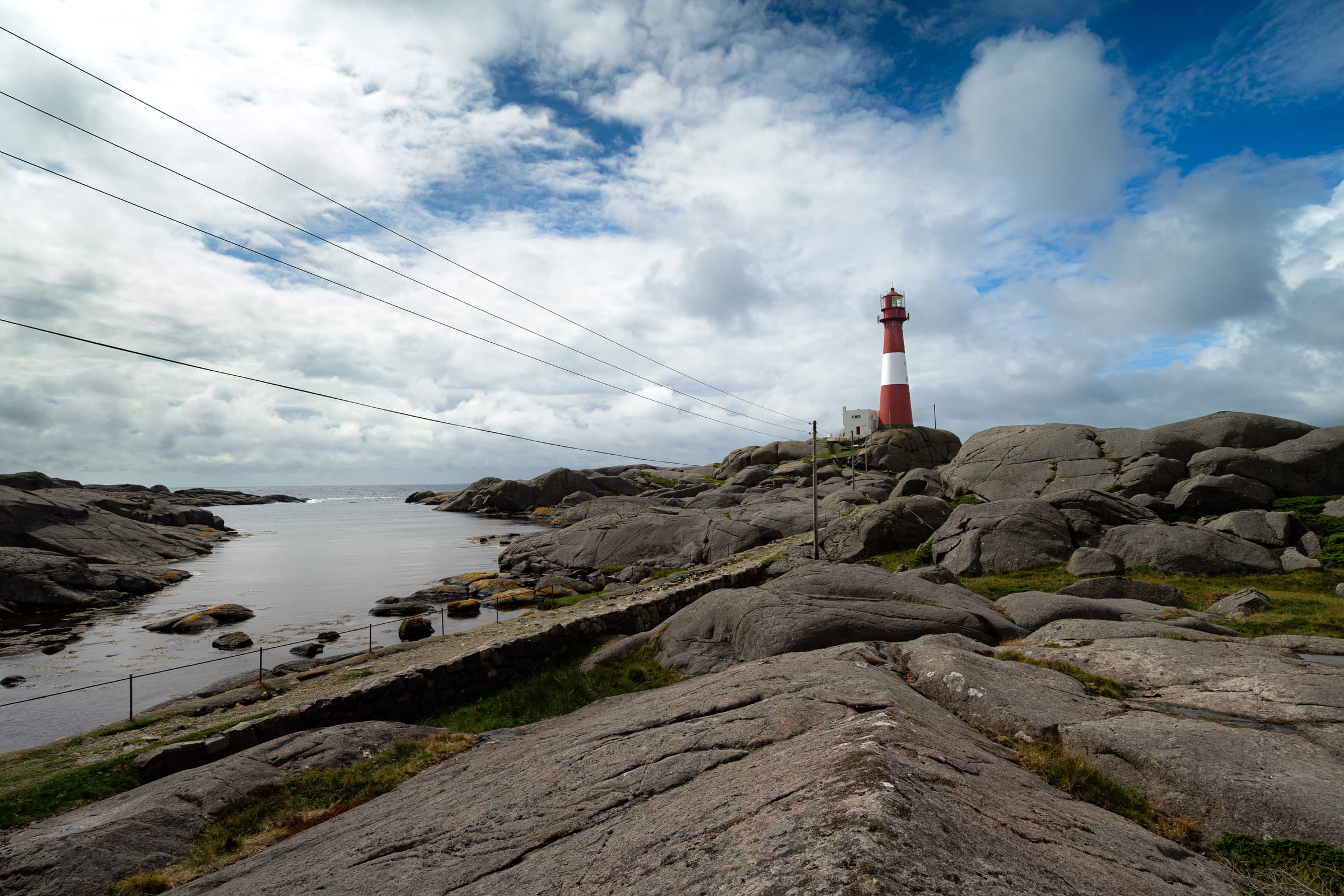 Lighthouse on a rocky coastline under a dramatic sky
