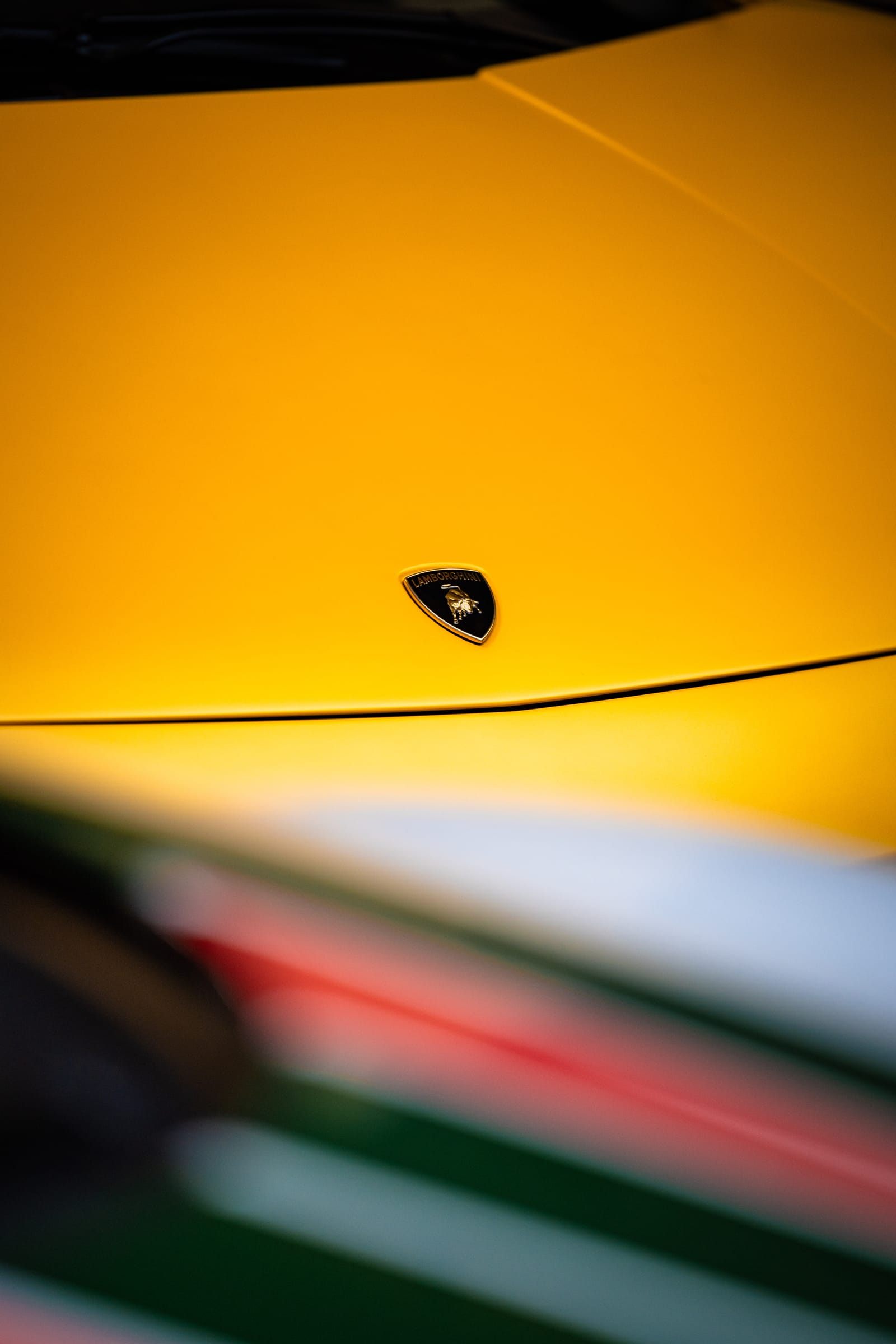Yellow Lamborghini detail with light reflections