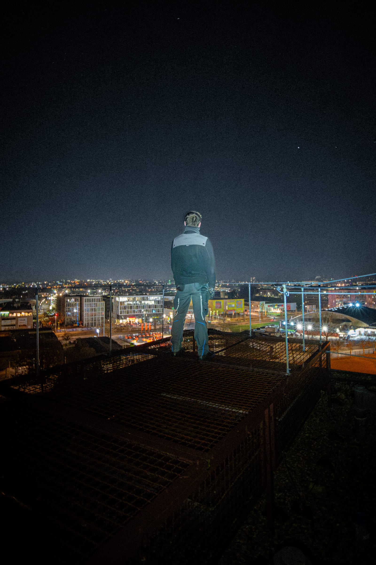 Person overlooking the illuminated city at night
